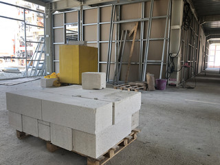 Piled cinder blocks on the floor of the prefabricated multi-storey building at the construction site