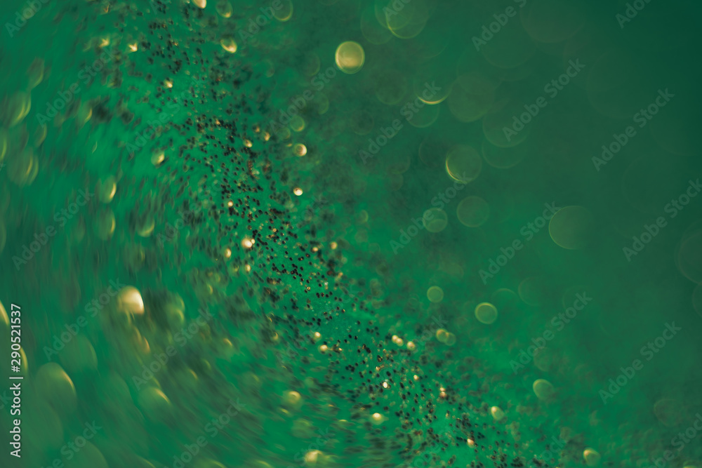 Poster beautiful abstact light bokeh on a green background.