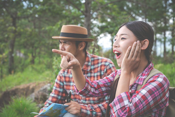 Fototapeta premium Both lovers are glad on the hills in the tropical forest, hiking, traveling, climbing.