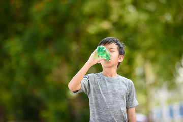 Young boy drink water.