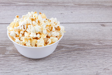 Popcorn on wooden background