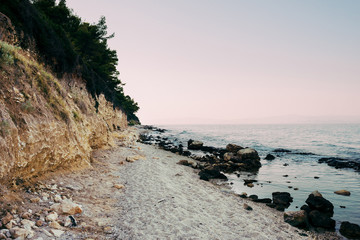 Fototapeta na wymiar sandy beach and sea at sunset in the summer