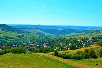 Fototapeta na wymiar a village between the hills of Transylvania seen from above