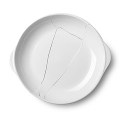 Broken white ceramic plate on a white floor with clipping path.