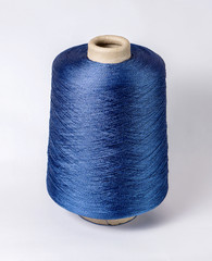 bobbin of yarn on a white background. Side view.Textile reel on isolated white background.