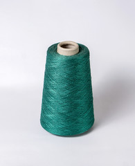 bobbin of yarn on a white background. Side view.Textile reel on isolated white background.