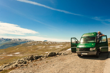 Fototapeta na wymiar Male tourist enjoy mountains landscape from camper van.