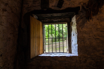 Fototapeta na wymiar old windows in a rural house with bars