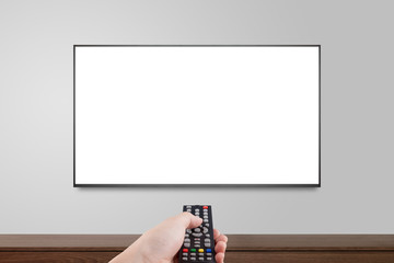 Television on white wall with hand using remote control, TV 4K flat screen lcd or oled, plasma...