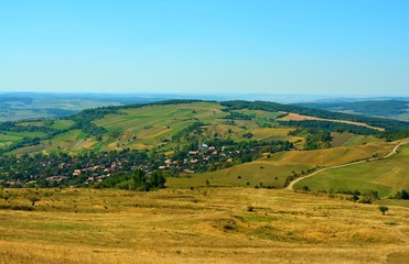 Fototapeta na wymiar a village between the hills of Transylvania seen from above