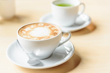hot coffee on table / hot cappuccino with nice pattern milk foam 
