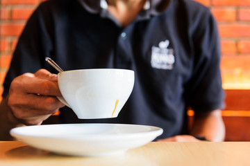 The man hold hot coffee in hand