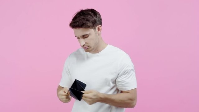 poor man shaking empty wallet isolated on pink