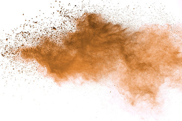 Abstract brown powder explosion. Closeup of brown dust particle splash isolated on white background
