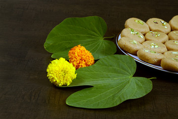Apta leaf and marigold flowers with sweet food, Dussehra or Dasara an Indian religious festival