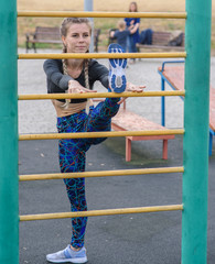 Girl stretches on the playground