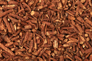 Dried medicinal herbs raw materials isolated on white. Root of Taraxacum