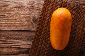 Papaya. Tropical Fruits. On a wooden background. Top view.