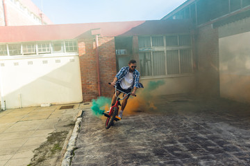 BMX rider using smoke grenades