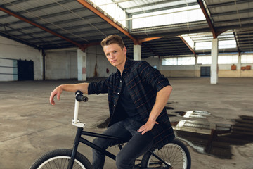 BMX rider in an empty warehouse