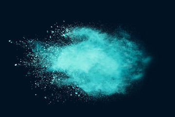 Explosion of aqua color powder on black background. 