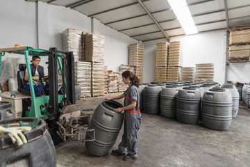 Women working in olives factory controlling fruit fermentation