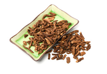 Dried medicinal herbs raw materials isolated on white. Root of Taraxacum, known as dandelions