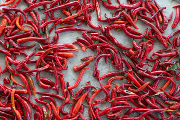 Drying long red pepper on the ground.