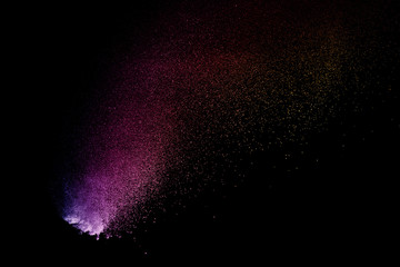 abstract colored dust explosion on a black background.abstract powder splatted background,Freeze...