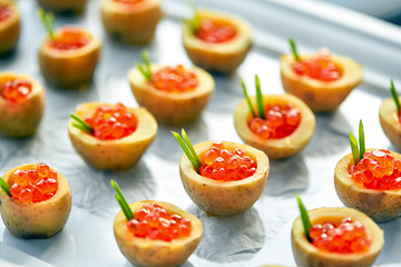 Delicious tartlets with red caviar. Concept of food, restaurant, catering, menu.