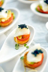 Delicious tartlets with black caviar. Concept of food, restaurant, catering, menu.