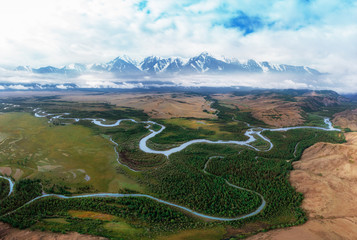 Kurai steppe and Chuya river on North-Chui ridge background. Altai mountains, Russia. Aerial drone panoramic picture.