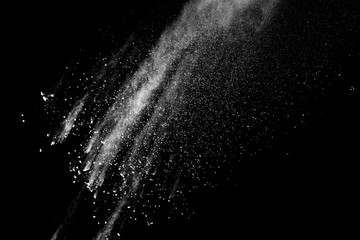 Freeze motion of white color powder exploding on dark background. 