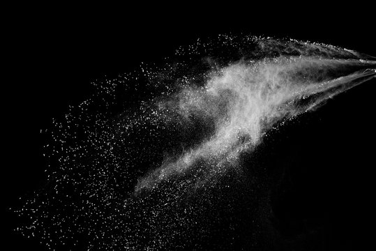 Freeze motion of white color powder exploding on dark background.