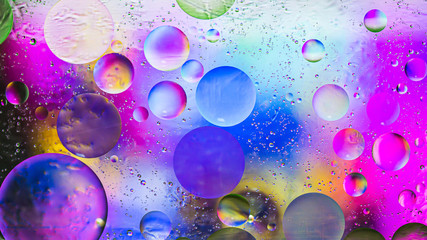 Colorful artistic image of oil drop on water for modern and creation design background.