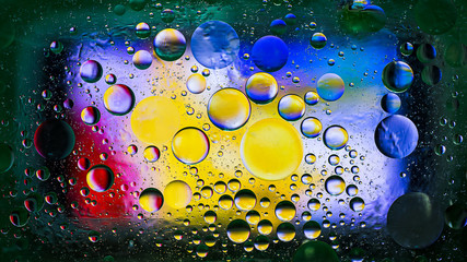 Colorful artistic image of oil drop on water for modern and creation design background.