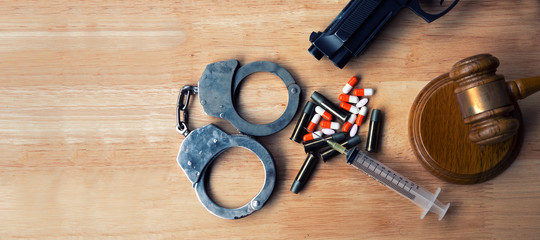 Drugs concept Drugs  handcuffs gun . Bulletwith a hammer of the judge