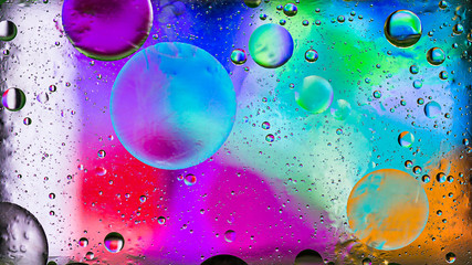 Colorful artistic image of oil drop on water for modern and creation design background.