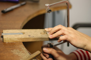 A jewelry master is working to create a silver ring