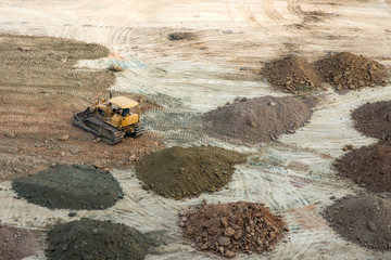 Grader, heavy truck working on construction site
