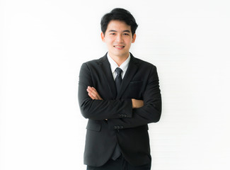 Portrait business man standing with arms crossed. wearing a black suit Isolated on white background