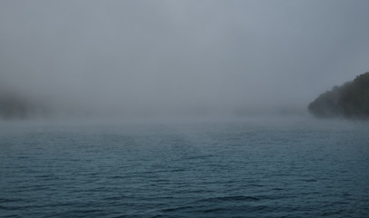 Autumn lake in Kamchatka is covered with fog. Lake Kamchatka autumn