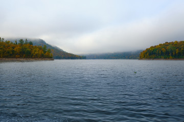 Foggy landscape in autumn on a lake in Norway in the mountains.