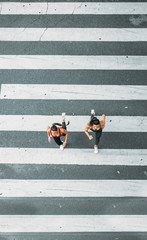 Two woman running for zebra crossing