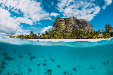 Tropical crystal ocean with Le Morne mountain and luxury beach in Mauritius. Split view.