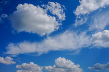 Naklejka na ściany i meble blue sky background with white fluffy clouds