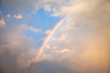 Fototapeta na wymiar Beautiful Rainbow in the Cloudy Sky