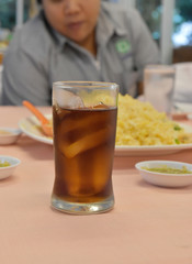 Cola in glass with ice in restaurant