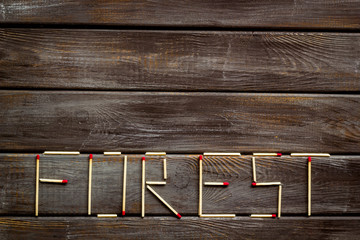 Fire concept with forest text on wooden background top view space for text