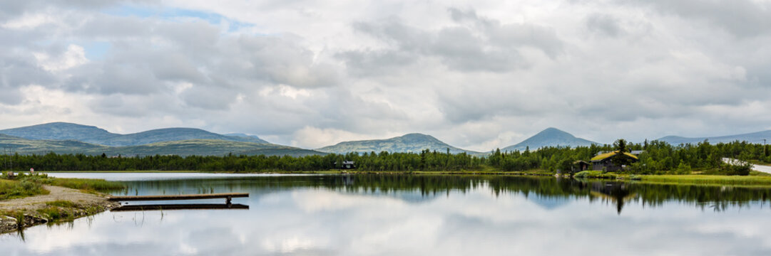 Panorama of Ringebu Kommune with view on a lake and the moutains of Rondane national Park in Oppland Norway